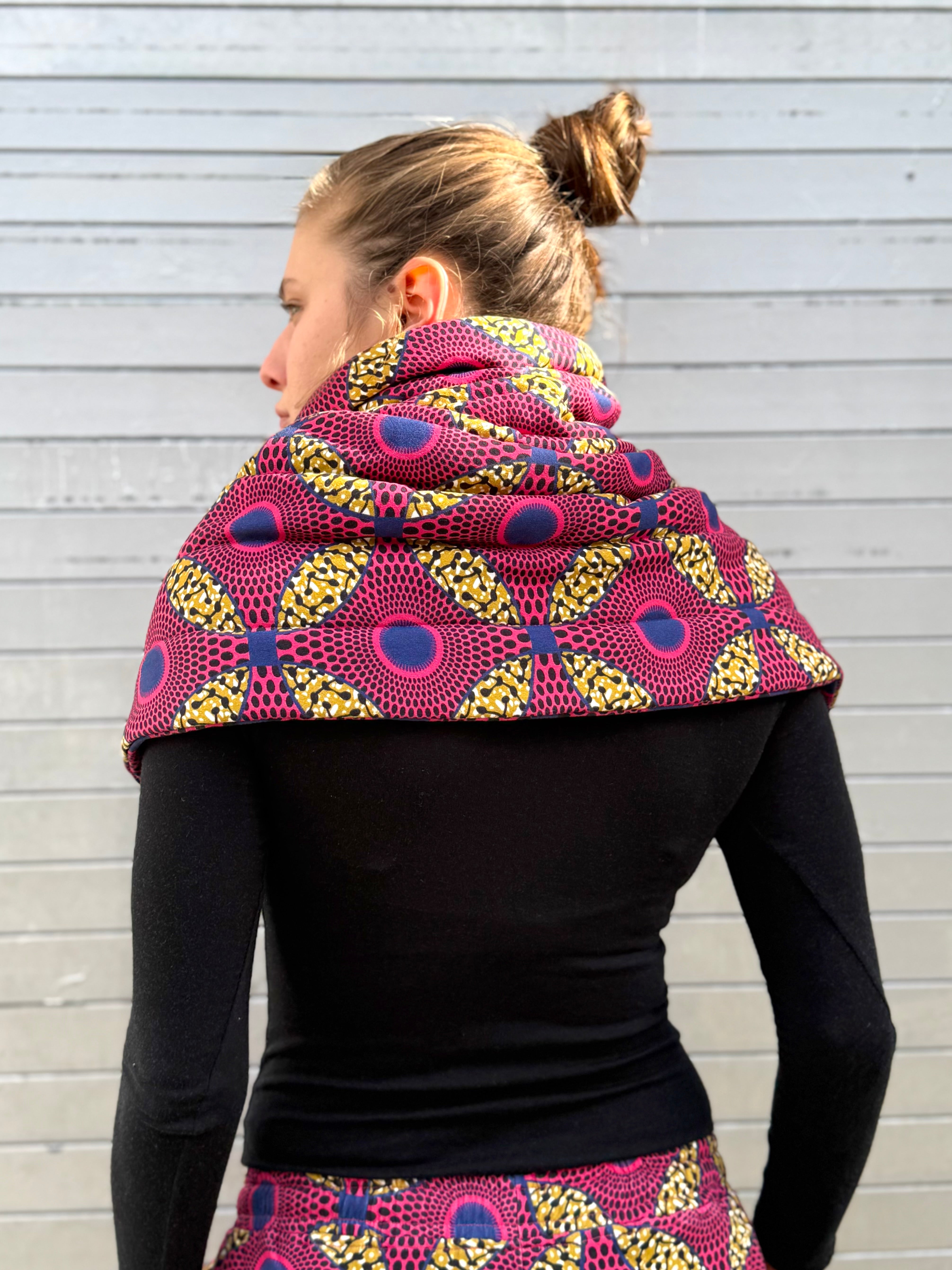Back view of the Ìmọ́lẹ̀ Pink Padded Sweat Scarf and matching pants by Lola Faturoti Loves. Featuring vibrant geometric African-inspired prints, organic cotton, and ethical small-batch production, it completes a look that honors heritage, joy, and mindful design.