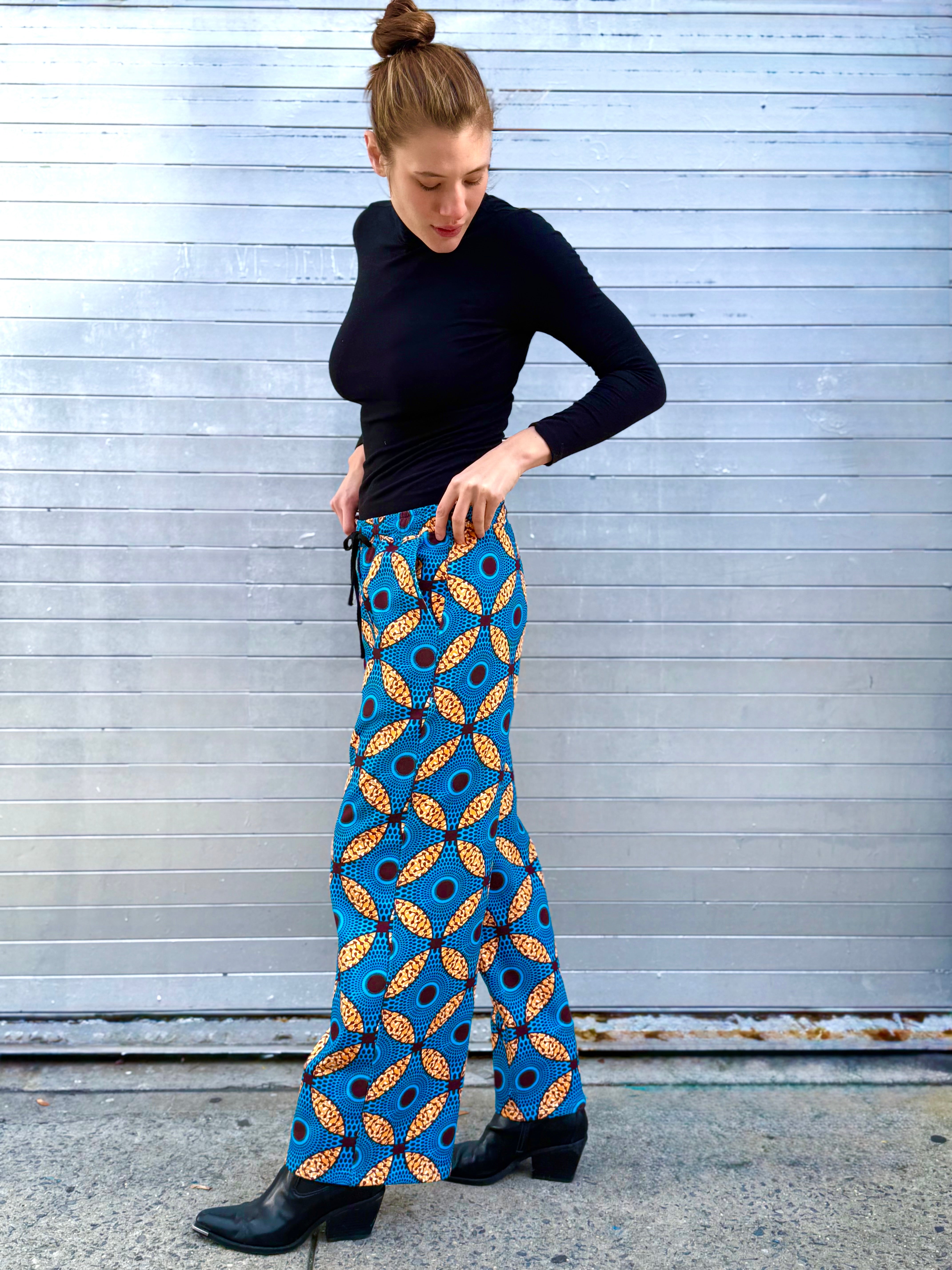 Side view of the Ìmọ̀lẹ̀ Blue Sweat Pants by Lola Faturoti Loves, highlighting the relaxed straight-leg silhouette and elastic waistband with drawstring. Ethically crafted in India, they embody comfort, culture, and conscious design.