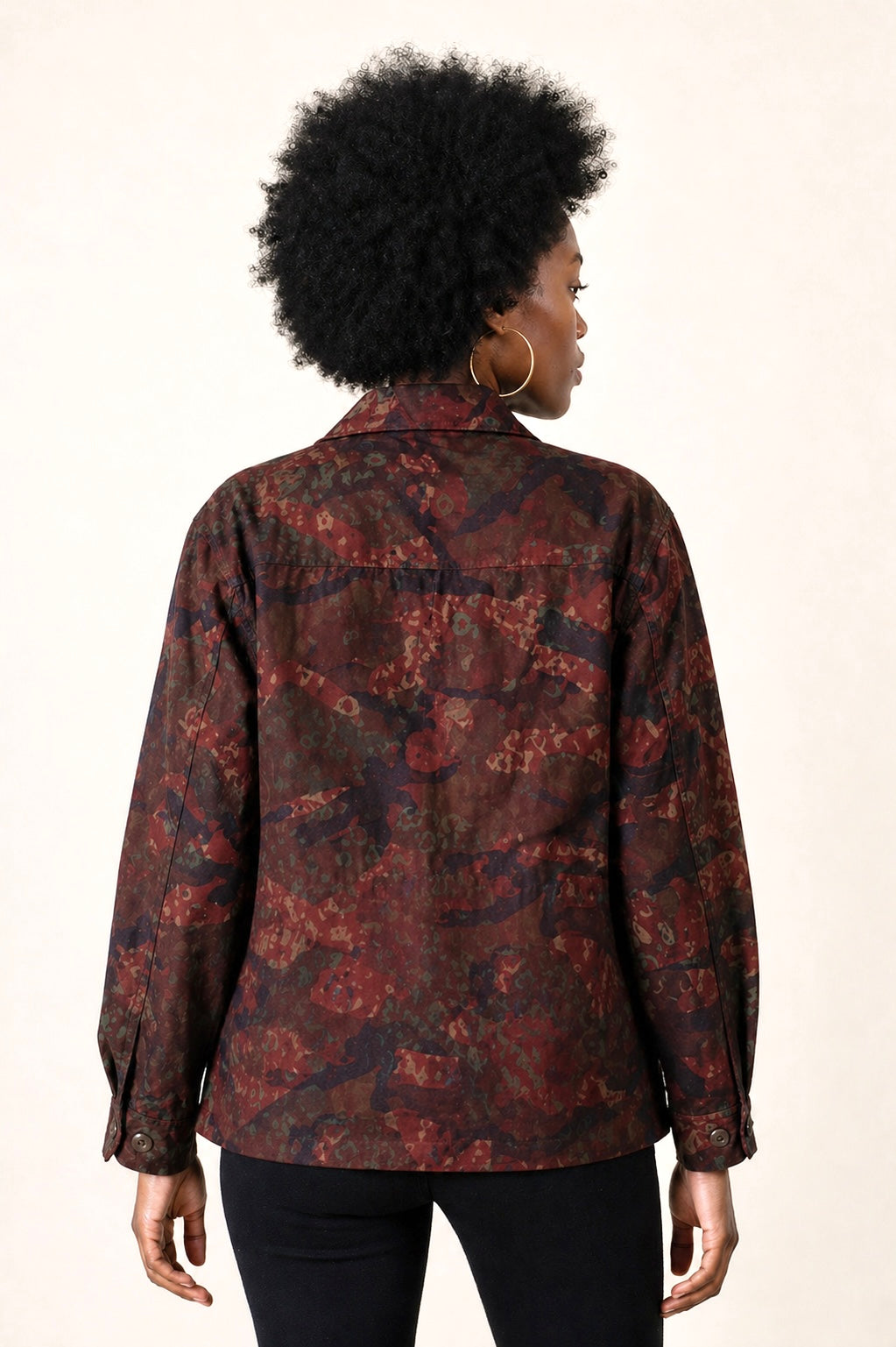 Exclusive reworked military jacket featuring earthy rust dye, subtle geometric patterning, and artisan mirror embroidery