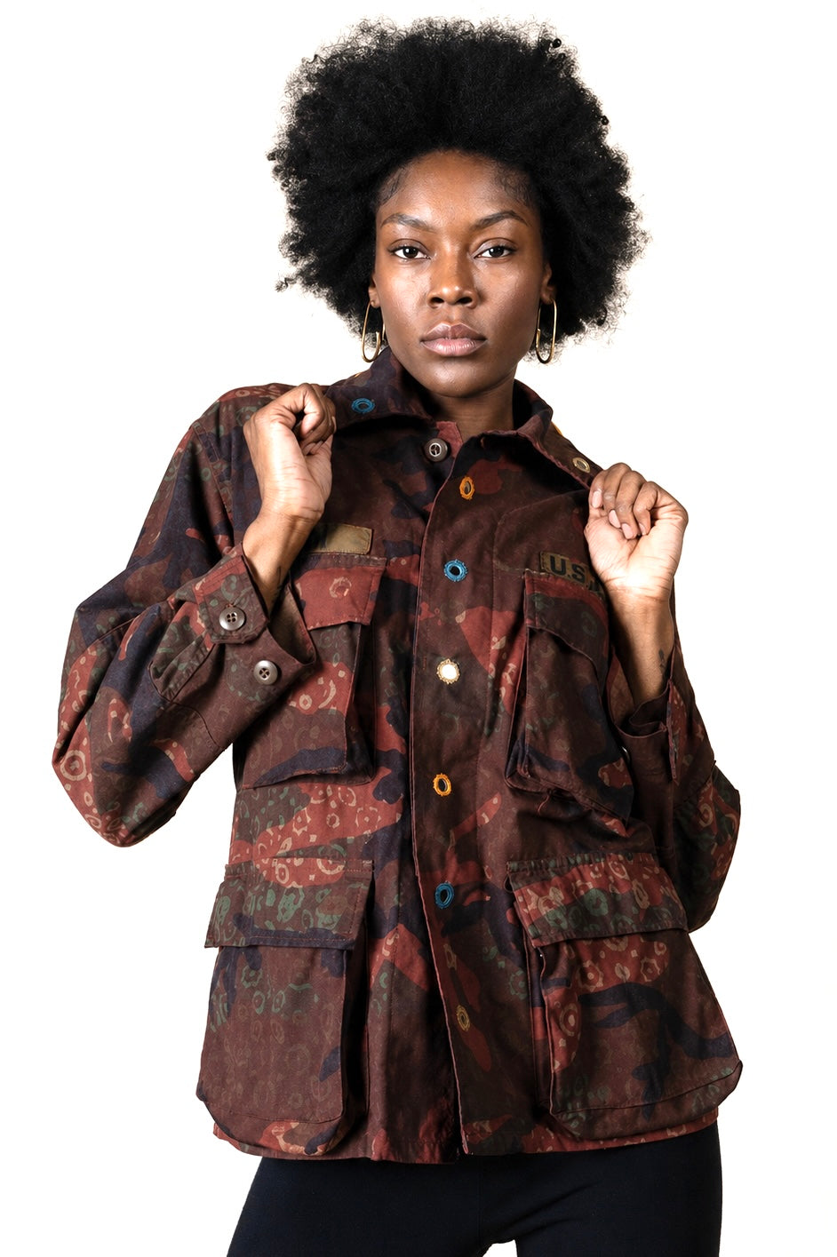 Exclusive reworked military jacket featuring earthy rust dye, subtle geometric patterning, and artisan mirror embroidery
