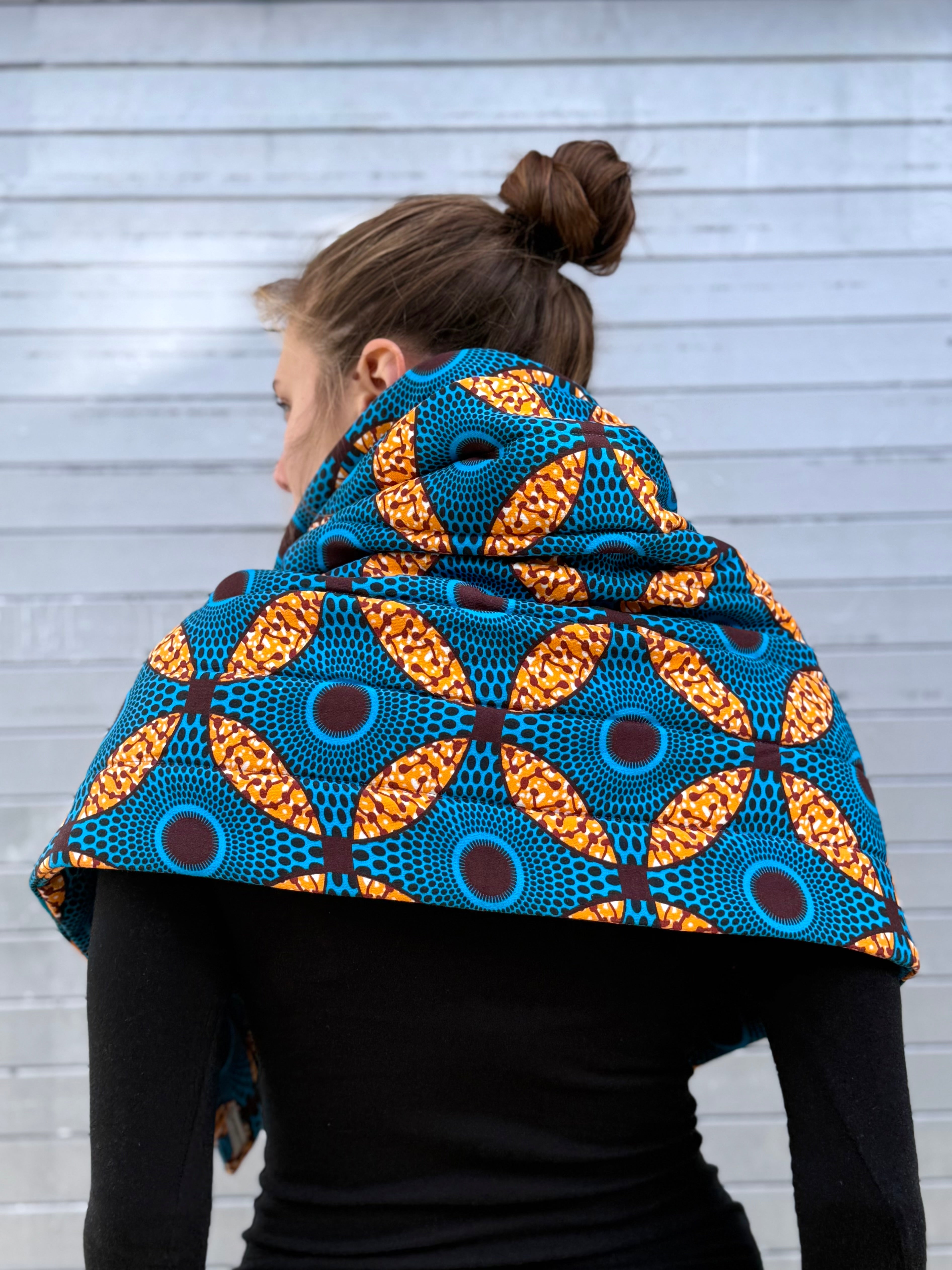 Back view of the Ìmọ́lẹ̀ Padded Sweat Scarf showing blue and gold geometric Yoruba pattern, handmade by Lola Faturoti Loves. Organic cotton scarf with geometric Yoruba-inspired motifs, designed for elegance and sustainability.