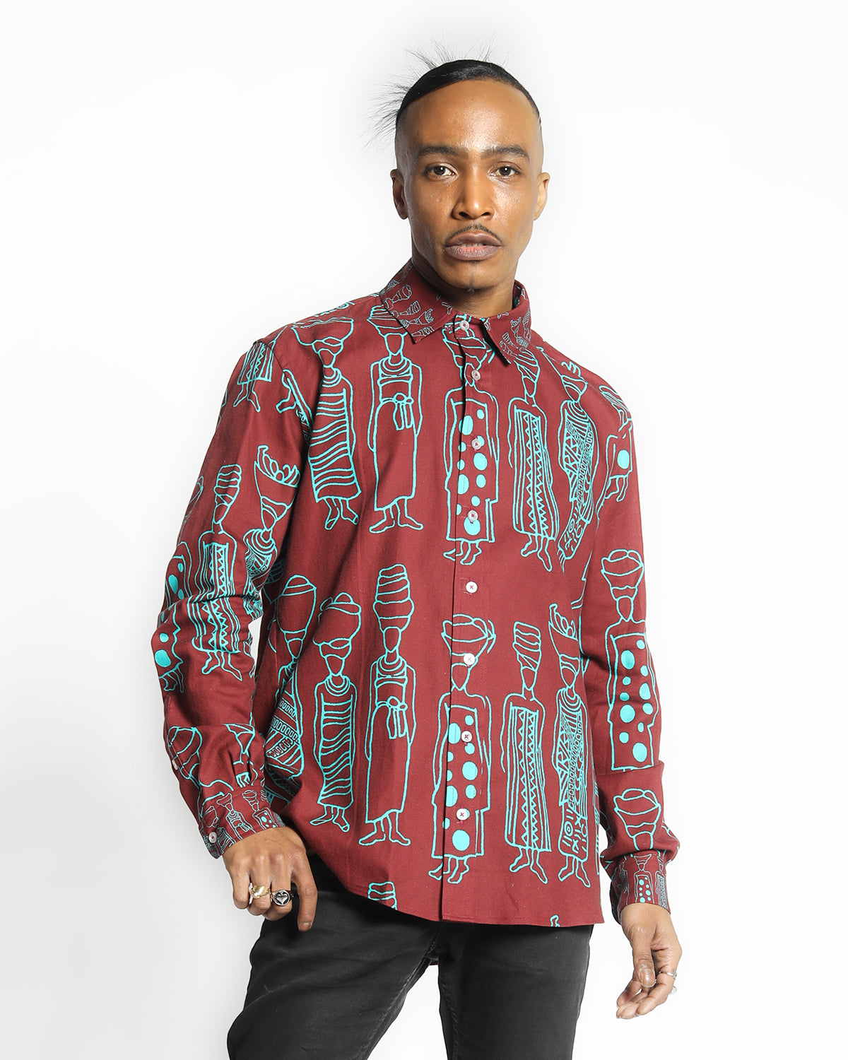 Model wearing long sleeve organic cotton shirt with African symbiolic motif