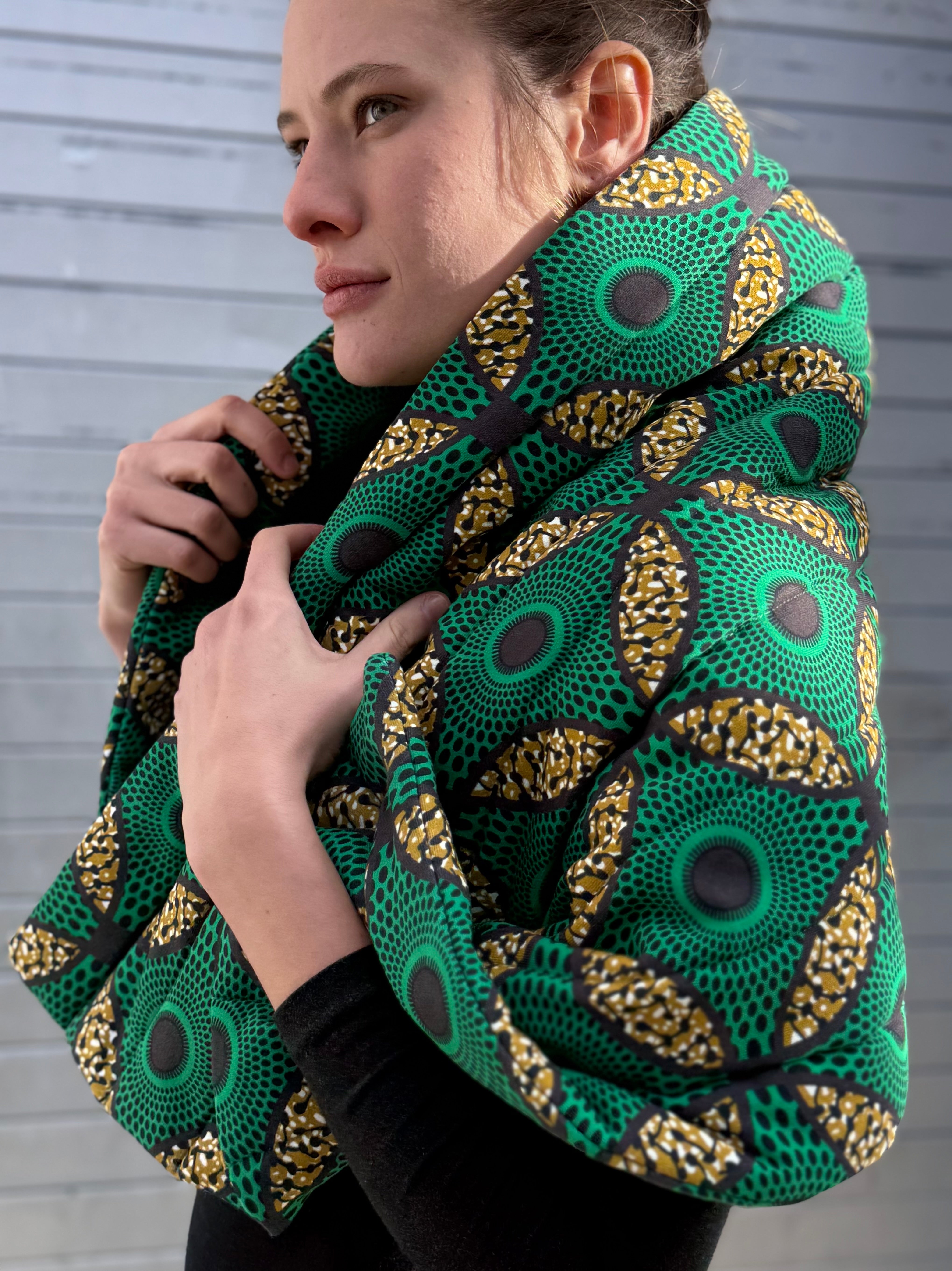 Portrait of model wearing the Ìmọ́lẹ̀ Green Padded Sweat Scarf, organic cotton with Yoruba patterns symbolizing strength, comfort, and sustainable elegance. The Imole Green Scarf by Lola Faturoti Loves reflects heritage and empowerment through vibrant Yoruba prints and ethical craftsmanship.