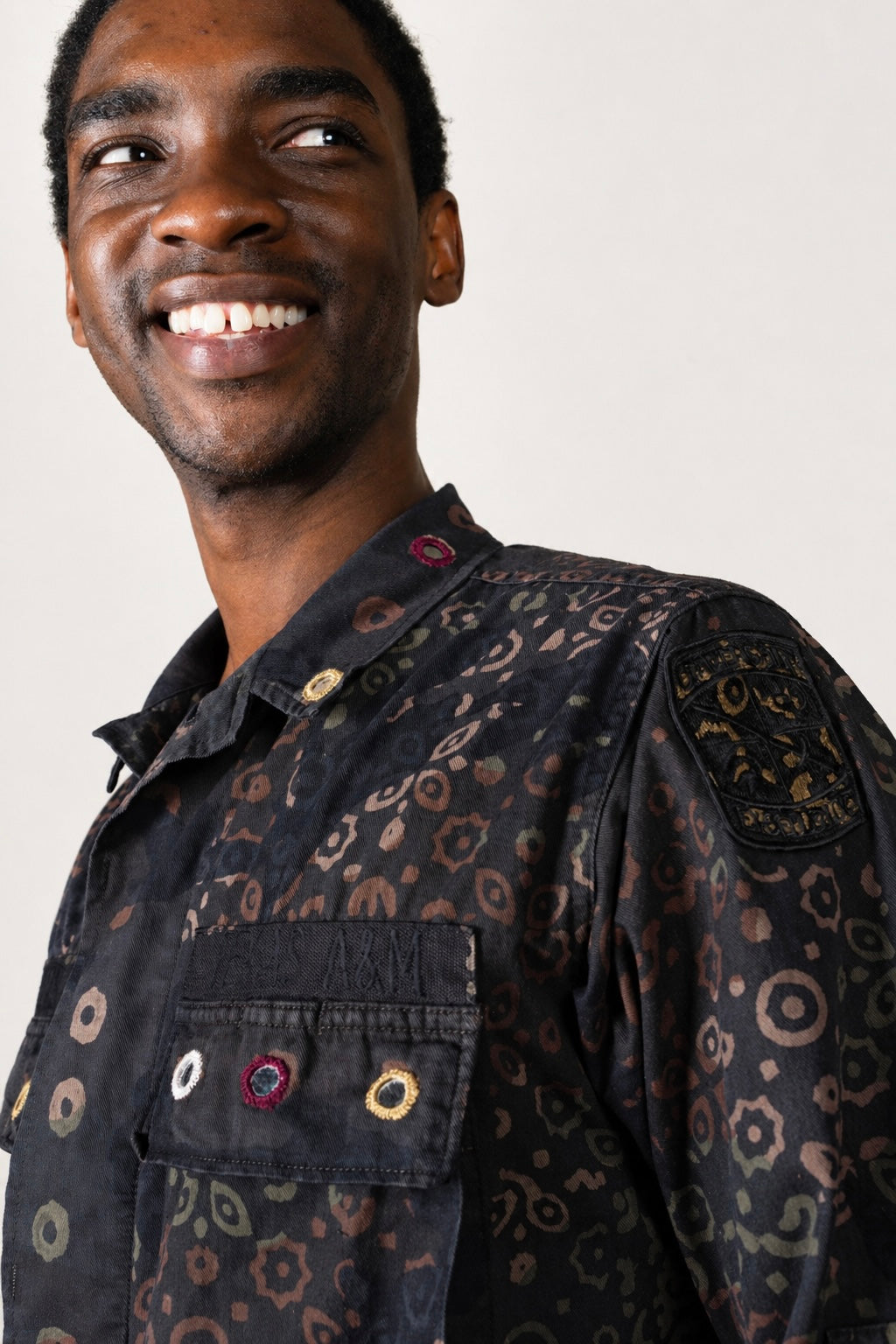 One-of-one vintage army jacket featuring tonal camouflage, natural iron dye process, and artisan mirror embroidery