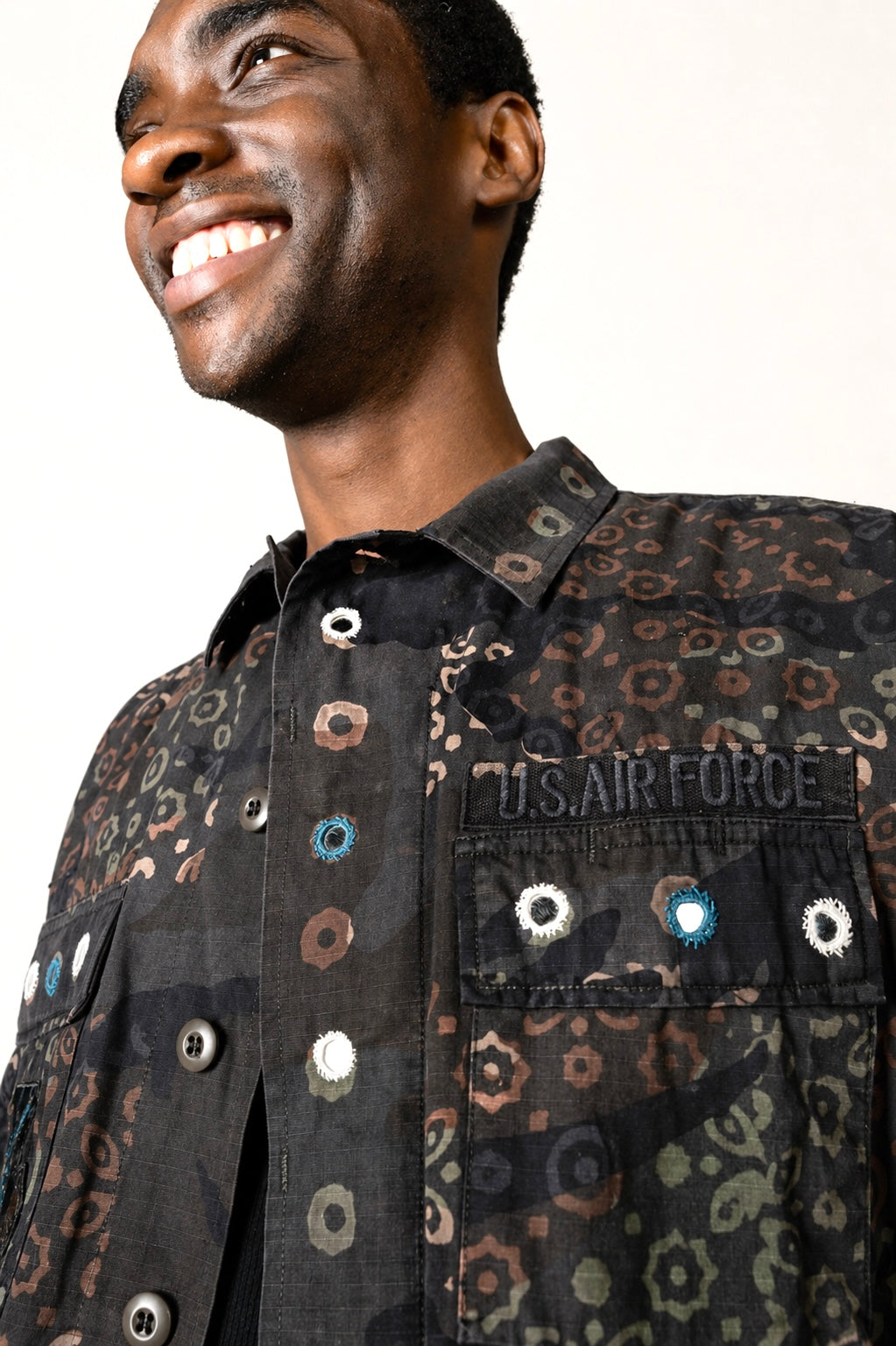 One-of-one vintage army jacket featuring tonal camouflage, natural iron dye process, and artisan mirror embroidery