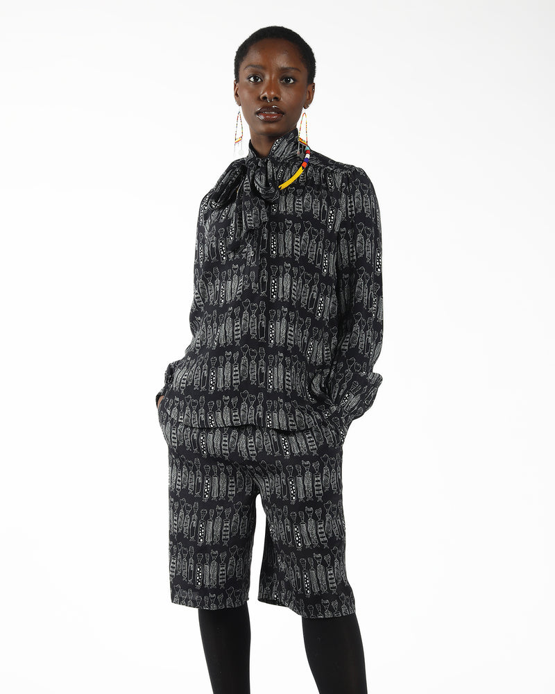 model wearing a African motif print blouse  made with ecovero viscose