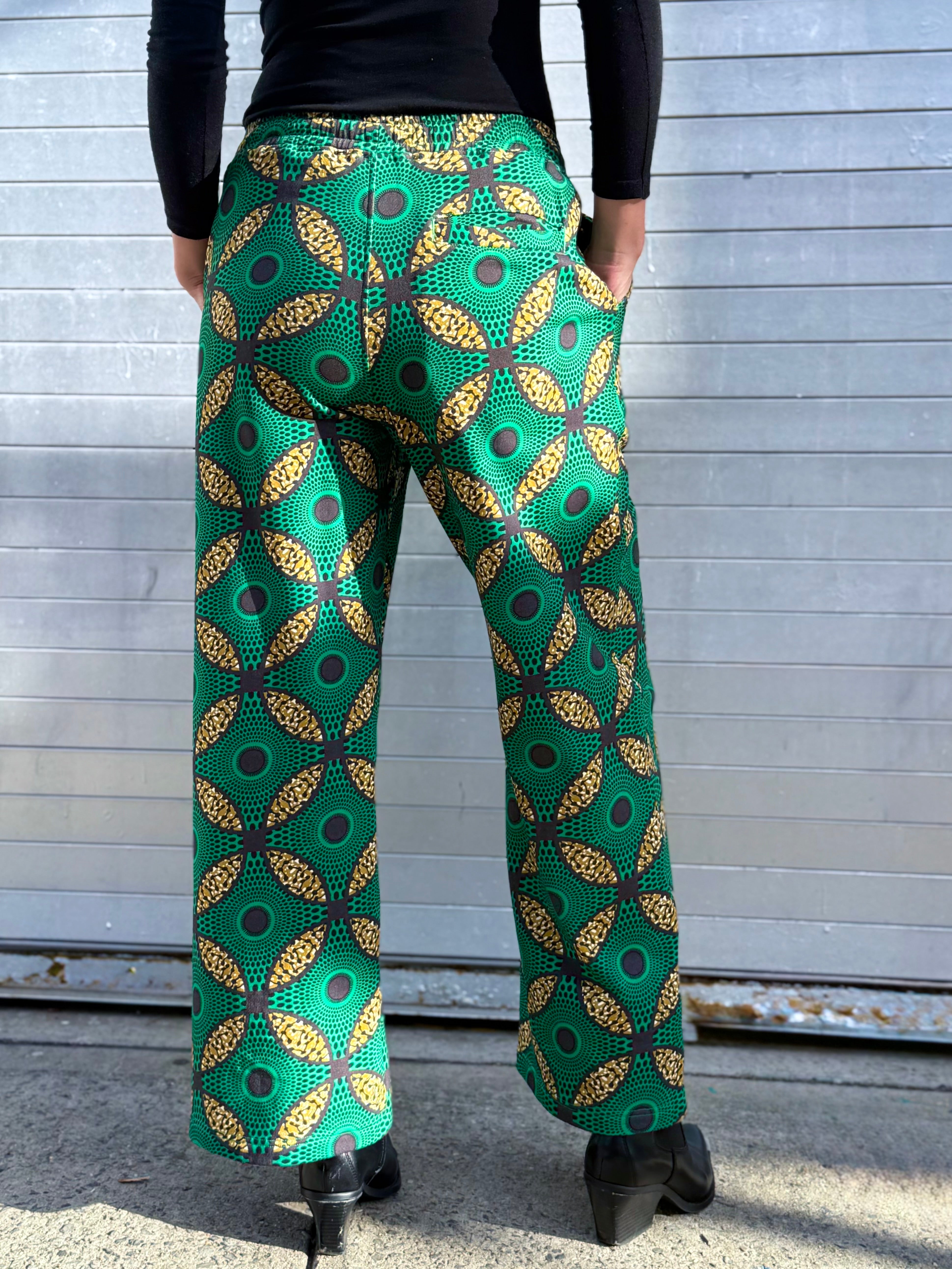 Back view of the Ìmọ̀lẹ̀ Green Sweat Pants by Lola Faturoti Loves, showing the intricate Yoruba-inspired motif and back pocket detail. Made to celebrate individuality, movement, and mindful fashion.